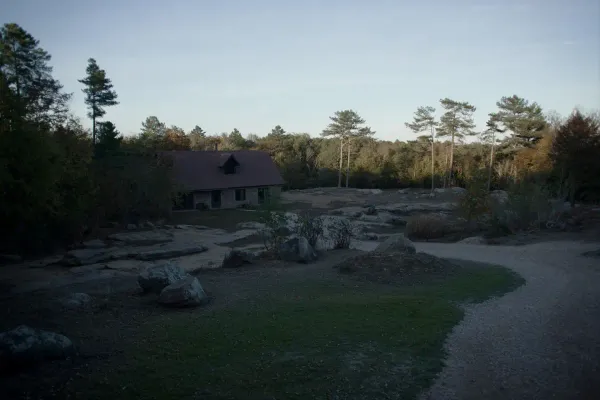 Rustic barndominium among pines and sandstone boulders on top of Lookout Mountain in DeKalb County, Alabama