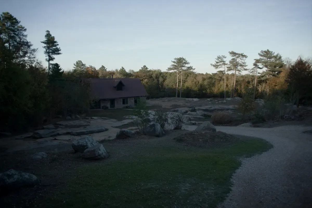 Rustic barndominium among pines and sandstone boulders on top of Lookout Mountain in DeKalb County, Alabama