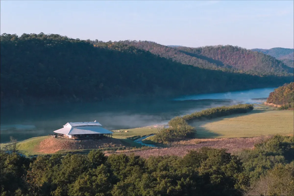 Post-frame home on a bench above the river valley between plateau walls in Jackson County, Alabama