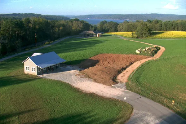 Barndominium home on a cleared lot beside row crops near Athens in Limestone County, Alabama